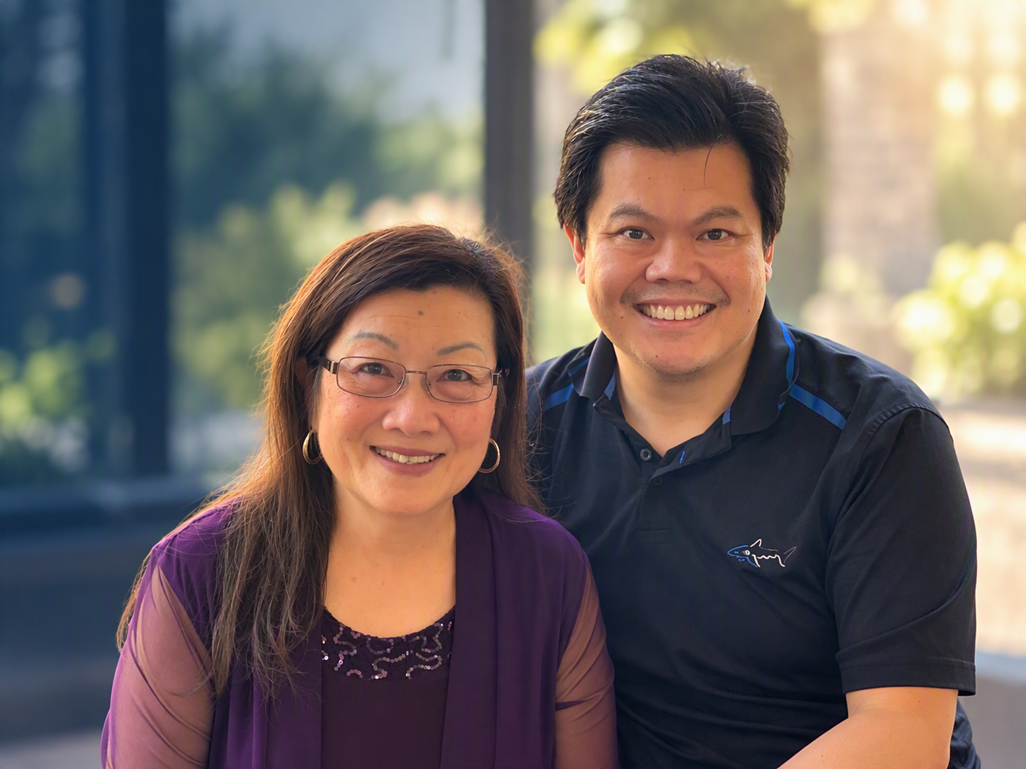 Two people seated together in a warmly lit indoor setting